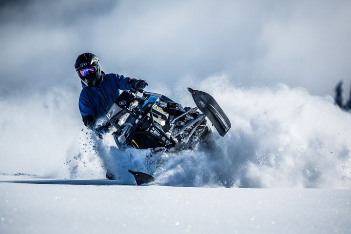 a man riding skis down a snow covered slope