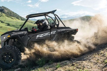 a car driving down a dirt road